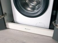 Detail of the Wide washing machine column with removable plinth for easy insertion of the appliance