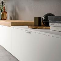Detail of the storage element for the living room with drawers called Plan equipped with top and M handle in white metal