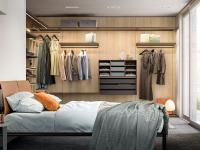 An example of a bedroom furnished with a Bliss Player walk-in corner wardrobe with wall panelling
