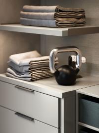 Practical surface areas are provided by shelves and drawer units