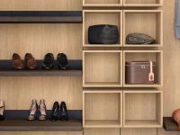 Square wall units in natural oak fashion wood beside a series of shoe-rack shelves 