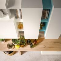 Detail of the wall system with wooden bench, above wall units with doors and open element in painted metal, White and Sky blue