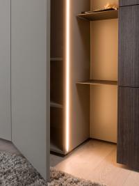 Detail of the protruding door and the built-in LED bar casting indirect light to the open compartment