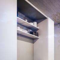 Detail of the matching shelves with back in gypsum textured melamine