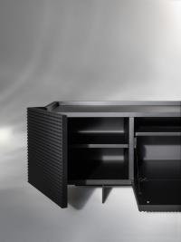 Detail of the internal compartments and corner opening system of the TV cabinet Fado