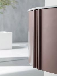 Detail of the full-height lacquered handle, one of the opening types available on the Atlantic curved bathroom cabinet