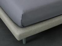 Detail of the upholstered thin bed-frame coverd in fabric