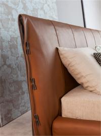 Detail of the elegant Cuff headboard with leather bows and pleats