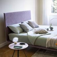 Thin bed by Bonaldo with smooth headboard
