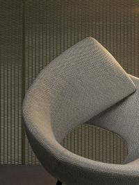 Close up of the curved structure of the Lock armchair, available in either fabric or leather