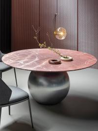 Elegant textural contrast between the Carpathian Red marble top and the chrome metal ball base
