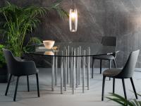 Mille round table by Bonaldo with clear glass table top and chromed metal cylindrical legs