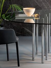Mille table with multiple cylindrical legs with round top and chromed metal legs by Bonaldo