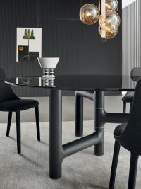 Pivot Round table in smoked glass with an asymmetrical base in brushed charcoal ash