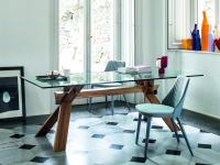 Neva upholstered chairs with lacquered part behind the backrest matching the legs, here pictured with Cavalletto table