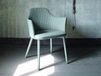 Neva upholstered chair with armrests and lacquered legs matching the cover