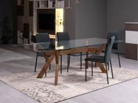 Larkin dining table with solid-wood sculptural base and clear glass top