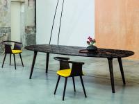Leander dining table with 4 tilted legs in solid wood and shaped rectangular top in Portoro marble