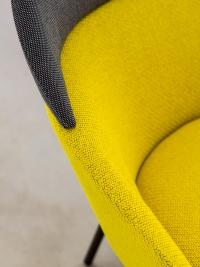 Detail of the frame padded with yellow fabric in constrat with the headrest