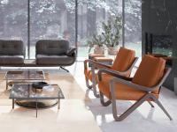 Taylor upholstered armchair with wooden armrests and cushions upholstered in leather