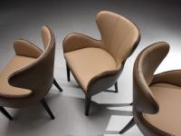 Elektra chair with armrests in a retro-style, enveloping design