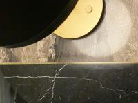 A close up of the bar inserted in between the two sections of the marble tabletop