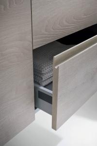 Detail of the drawer with metal frame and recessed handle