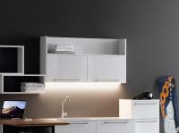 Pair of Oasis wall units with flip-up opening. With open elements from the same collection on top (LED bar not included)