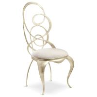 Ghirigori chair with sabre-shaped legs and metal swirls seat-back