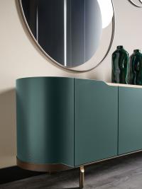 Close up of Circe round mirror positioned on the wall above an Oasi sideboard