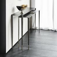 View from the side of set of two painted steel brushed grey console tables