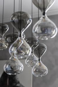 Detail of the hourglass-shaped lampshades of the lamp Sablier by Cattelan