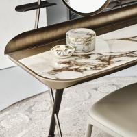 Detail of the ceramic top with marble effect and profile in painted metal brushed bronze