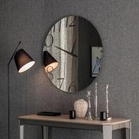 Moment wall mirror clock by Cattelan, next to Nemo console table by Cattelan