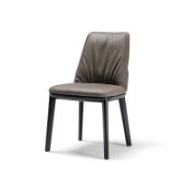 Frontal view of belinda chair by Cattelan with soft upholstery and wooden chairs
