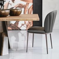 Chrishell upholstered chair with shaped-sell finish matched to Mad Max Wood by Cattelan table