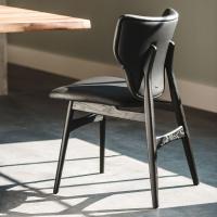 Dumbo is a chair with modern winged seatback  covered in 973 black
