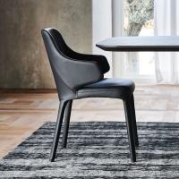 Wanda is an upholstered chair with embracing arms by Cattelan that ensures maximum comfort around a classy and elegant dining table