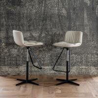Axel is a stool with feetrest that is swivel and adjustable