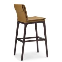 View from the side of Sofia by Cattelan upholstered stool with back with wood beech structure, the upholstered pillow lays on the back