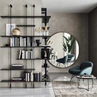 Wish mirror in the round model with diameter of 181 cm, paired with the Airport bookcase