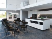 Open plan villa with black and white kitchen and island with cook top