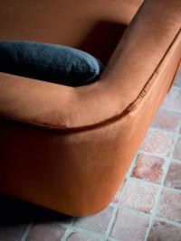 Detail of the flared back with shaped corner and velvet upholstery finished with raised border