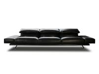 Heritage designer sofa upholstered in black leather with low, padded horizontal armrests