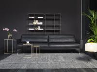 Maxime 3-seater sofa upholstered in black leather with high black feet with a brass tip and 14 cm wide armrests