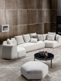 Panorama New sectional sofa with hexagonal elements with a matching pouffe, available with low semi-hidden wooden feet (like the sofa structure) with wheels