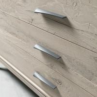 Detail of the rough cut oak wood drawers and metal handles