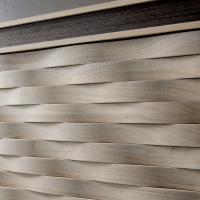 Detail of Armonia door decoration in natural grey solid walnut wood