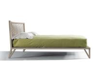 Katai is a slim real wood bed frame, with high feet and curved headboard