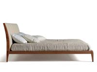 Michiko bed with high feet and upholstered headboard, view from the side